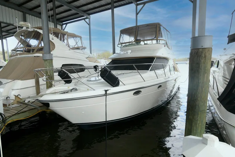 Slide: The Image of 2001 Maxum 4100 SCB yacht docked under a covered marina. - 1