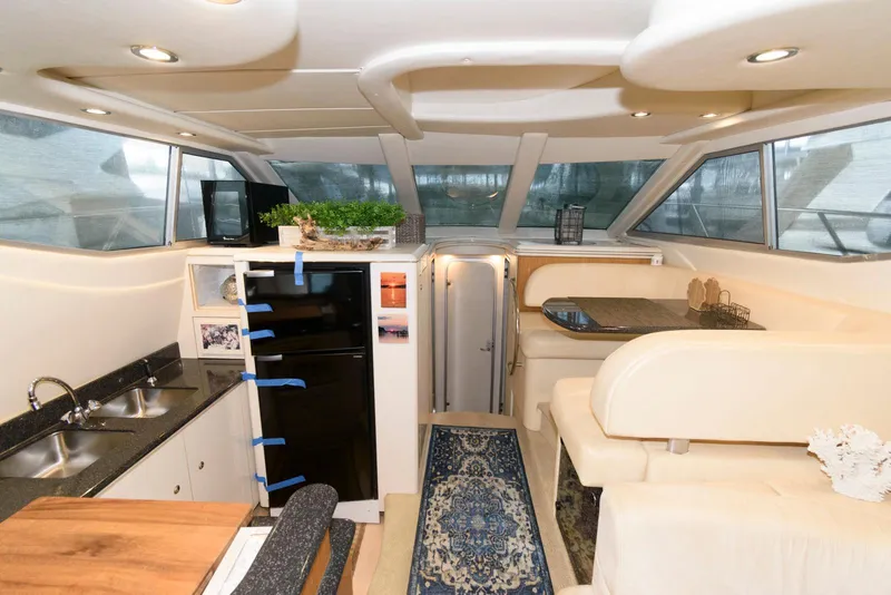 Slide: The Image of Interior of 2001 Maxum 4100 SCB yacht with modern kitchen and seating area. - 15