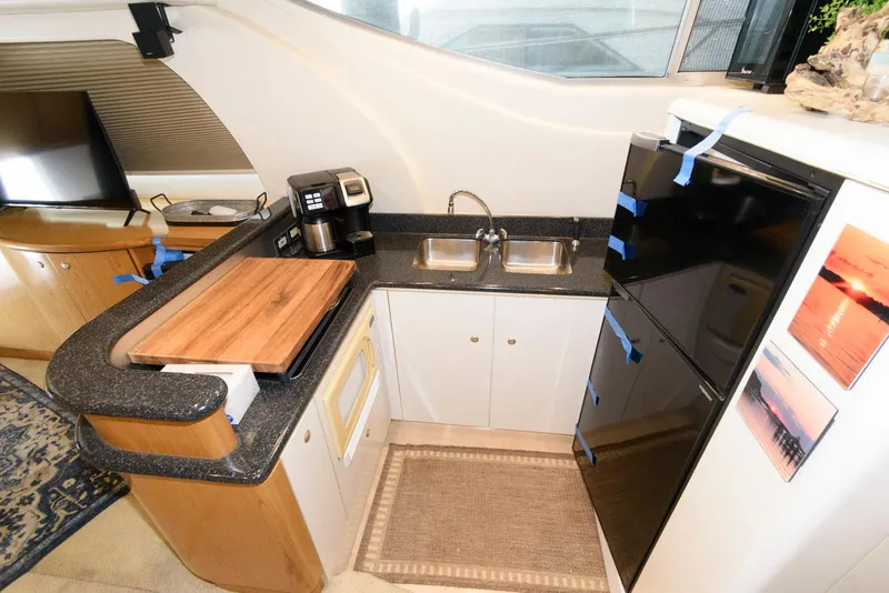 Slide: The Image of 2001 Maxum 4100 SCB yacht kitchen with sink, countertop, and appliances. - 16