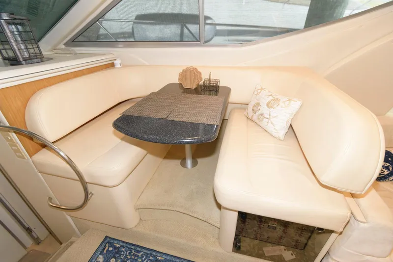 Slide: The Image of 2001 Maxum 4100 SCB yacht interior with beige seating and dining table. - 17