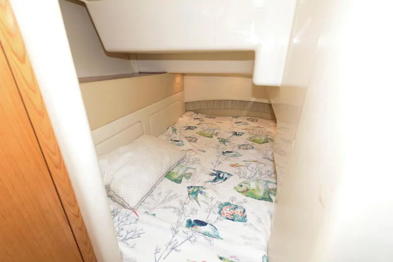 Slide: The Image of Cozy cabin interior of 2001 Maxum 4100 SCB with patterned bedding. - 19