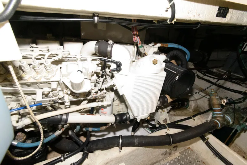 Slide: The Image of Engine compartment of 2001 Maxum 4100 SCB boat, showcasing mechanical components and wiring. - 21