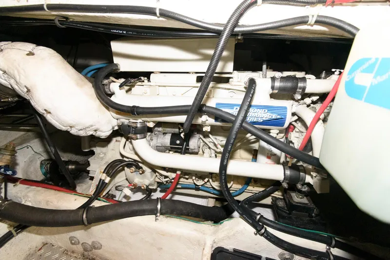 Slide: The Image of Engine compartment of a 2001 Maxum 4100 SCB boat, showcasing mechanical components and wiring. - 22