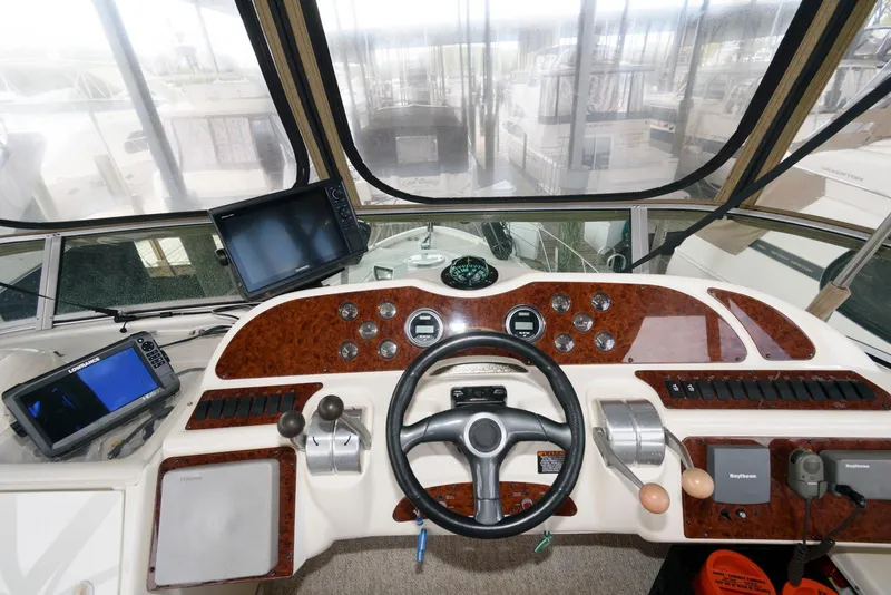 Slide: The Image of Cockpit of 2001 Maxum 4100 SCB yacht with navigation equipment and steering wheel. - 8