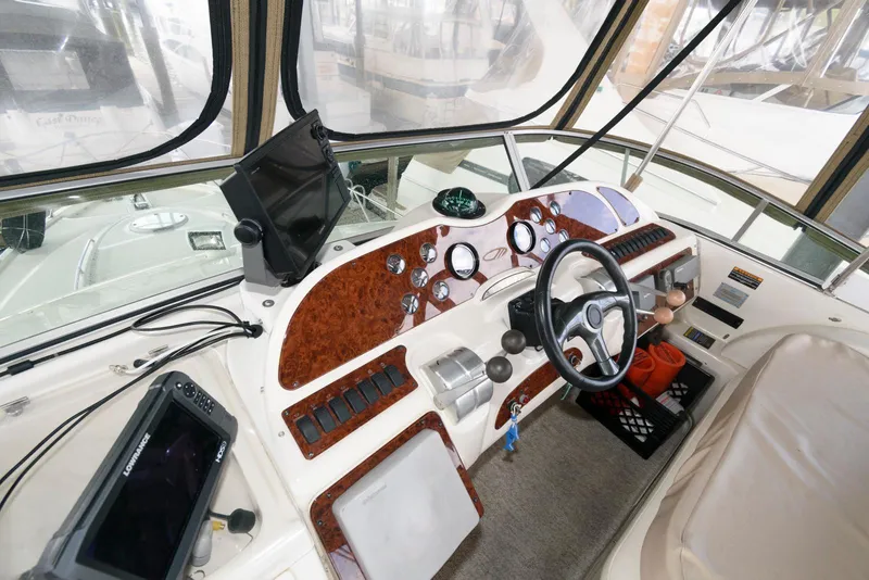 Slide: The Image of 2001 Maxum 4100 SCB boat cockpit with steering wheel and navigation instruments. - 9