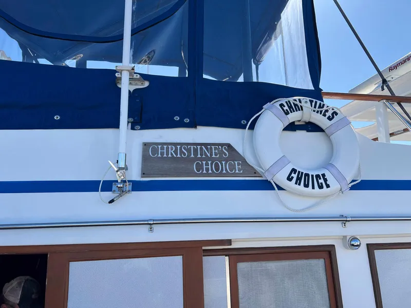 Slide: The Image of 1983 Lindmark 39 Trawler named "Christine's Choice" with life preserver on deck. - 11