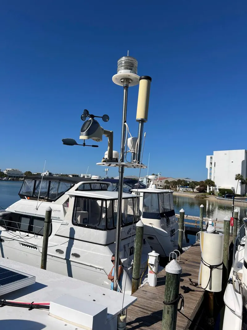 Slide: The Image of 1983 Lindmark 39 Trawler docked at marina under clear blue sky. - 12