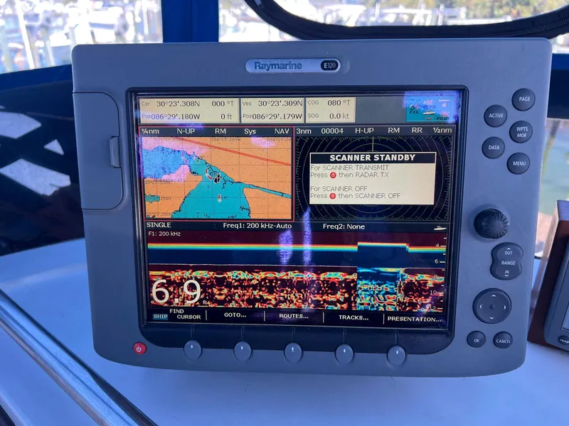 Slide: The Image of Raymarine navigation display on 1983 Lindmark 39 Trawler, showing marine charts and sonar data. - 15