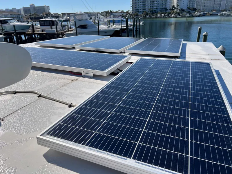 Slide: The Image of Solar panels on 1983 Lindmark 39 Trawler, docked at marina with boats and buildings in background. - 19