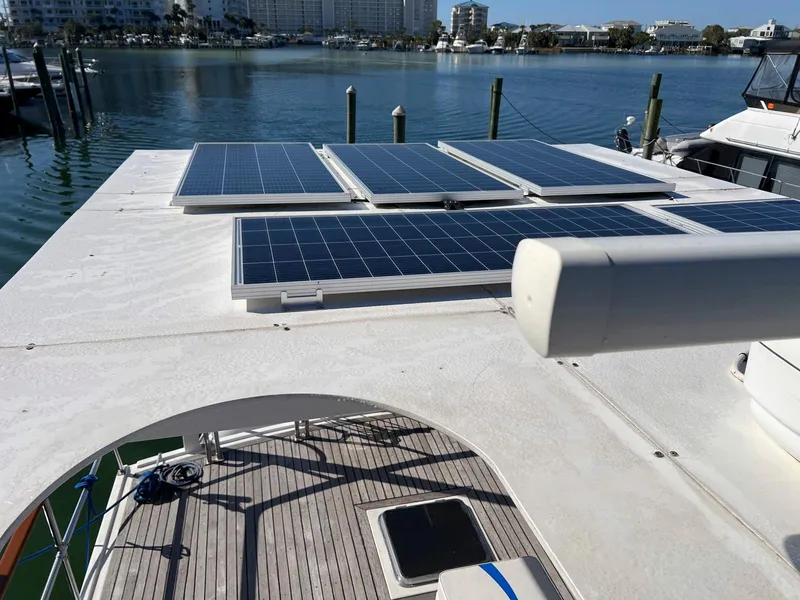 Slide: The Image of 1983 Lindmark 39 Trawler with solar panels on deck, docked in a marina. - 22