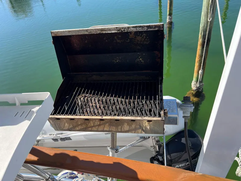 Slide: The Image of Open grill on a Lindmark 39 Trawler, 1983, with water and dock in the background. - 24