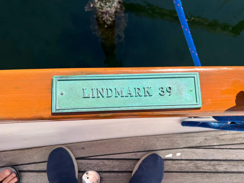 Slide: The Image of Plaque on 1983 Lindmark 39 Trawler boat, wooden deck visible. - 29