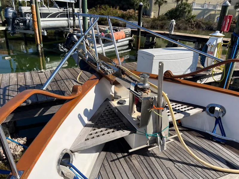 Slide: The Image of 1983 Lindmark 39 Trawler docked, showcasing bow details and mooring equipment. - 33