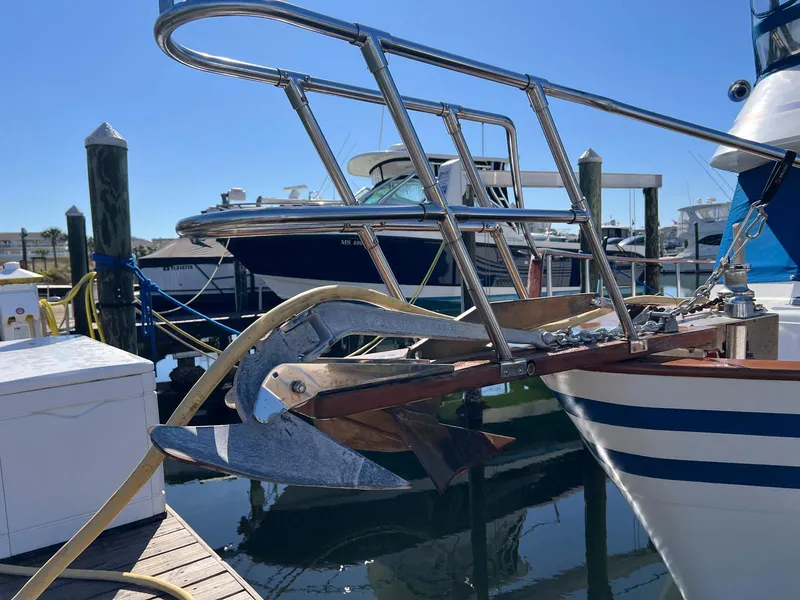 Slide: The Image of 1983 Lindmark 39 Trawler docked, featuring a prominent anchor and bow railing. - 5