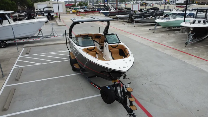 Slide: The Image of 2022 Chaparral 28 Surf boat on trailer in marina parking lot. - 12
