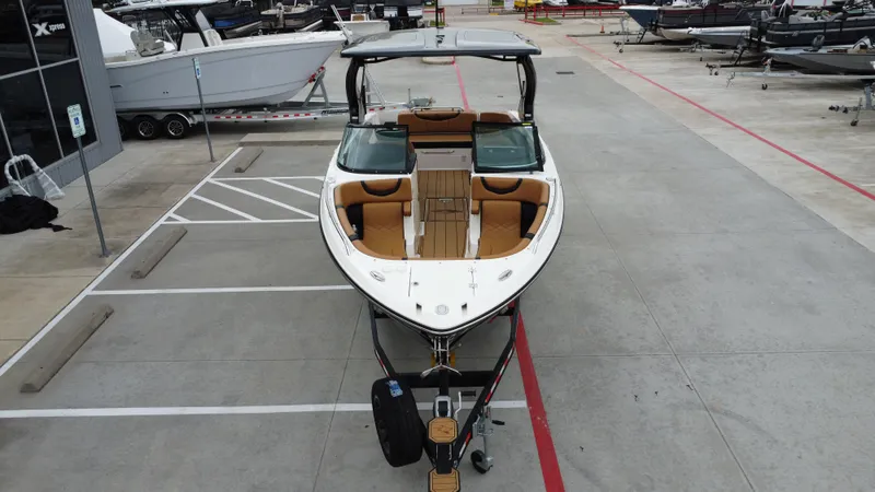 Slide: The Image of 2022 Chaparral 28 Surf boat on trailer in a parking lot. - 13