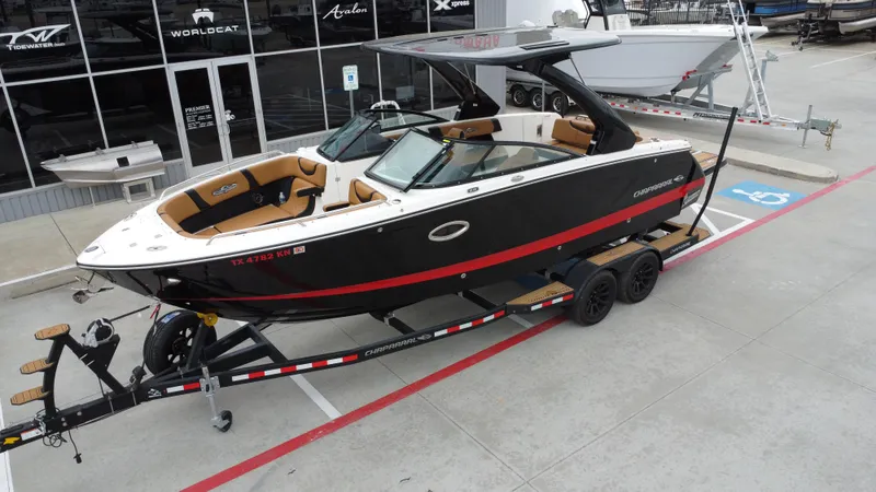 Slide: The Image of 2022 Chaparral 28 Surf boat on trailer, parked in marina lot. - 14