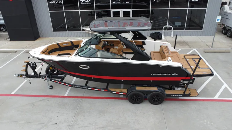 Slide: The Image of 2022 Chaparral 28 Surf boat on trailer, parked outside dealership. - 15