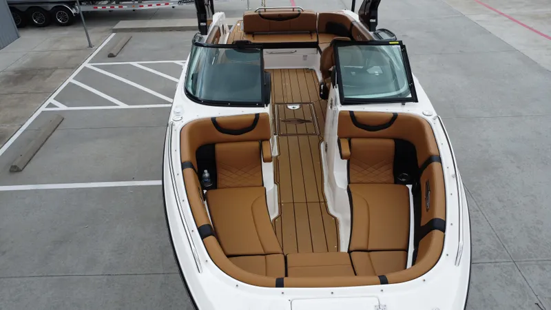 Slide: The Image of 2022 Chaparral 28 Surf boat with spacious tan seating and sleek design. - 19