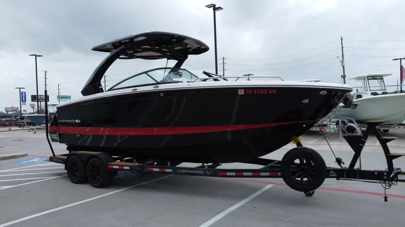 Slide: The Image of 2022 Chaparral 28 Surf boat on trailer in parking lot, overcast sky. - 3