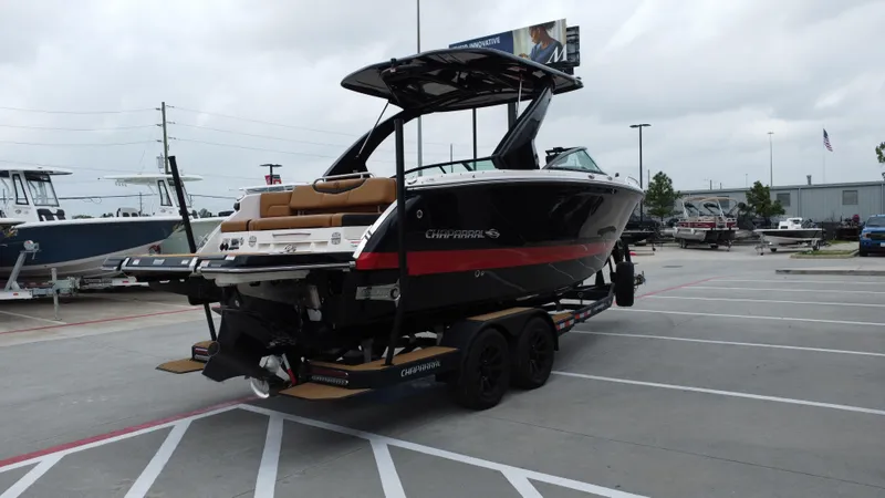 Slide: The Image of 2022 Chaparral 28 Surf boat on trailer in parking lot, overcast sky. - 9