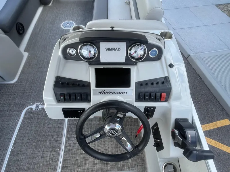 Slide: The Image of 2020 Hurricane FunDeck 236WB OB boat dashboard with steering wheel and control panel. - 4