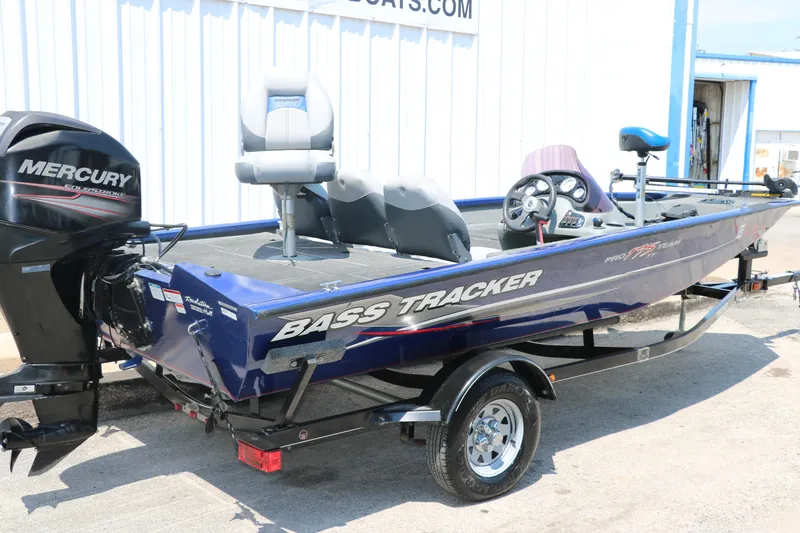 Slide: The Image of 2014 Bass Tracker PT175TF boat with Mercury engine, parked outdoors. - 13