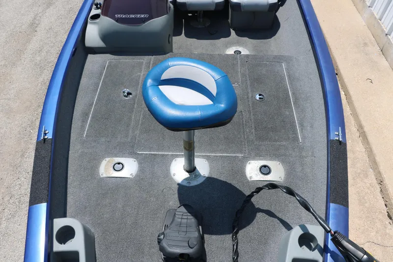 Slide: The Image of 2014 Bass Tracker PT175TF boat interior with blue seat and carpeted deck. - 20