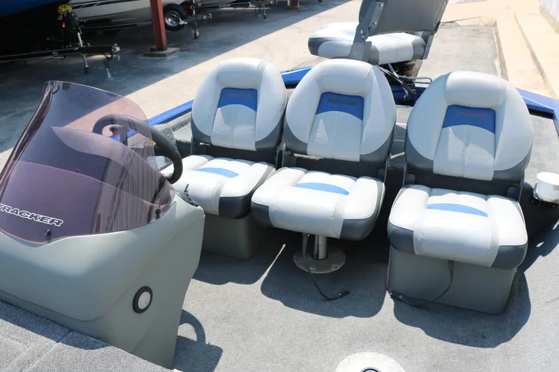 Slide: The Image of 2014 Bass Tracker PT175TF boat interior with four cushioned seats and steering console. - 22