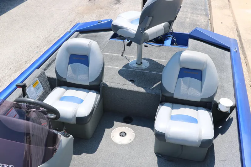 Slide: The Image of 2014 Bass Tracker PT175TF boat interior with three gray and blue seats. - 26