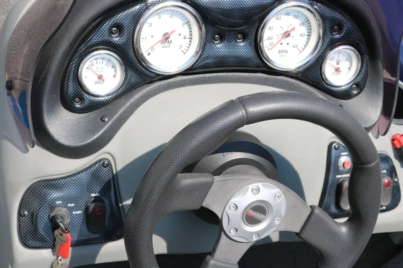 Slide: The Image of Dashboard of 2014 Bass Tracker PT175TF boat with steering wheel and gauges. - 28