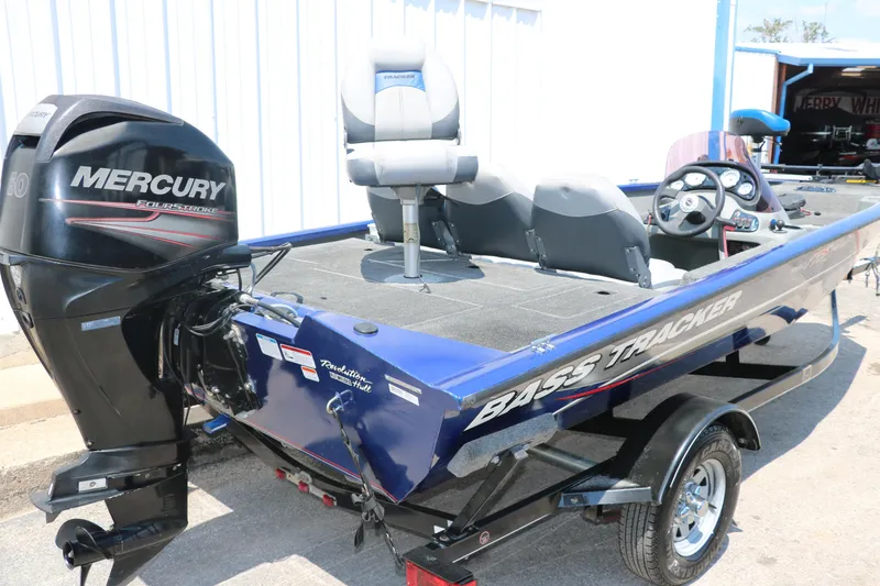 Slide: The Image of 2014 Bass Tracker PT175TF boat with Mercury engine, parked outdoors. - 4