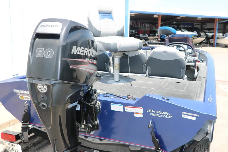 Slide: The Image of 2014 Bass Tracker PT175TF boat with Mercury 50 engine, blue exterior, parked in marina. - 5