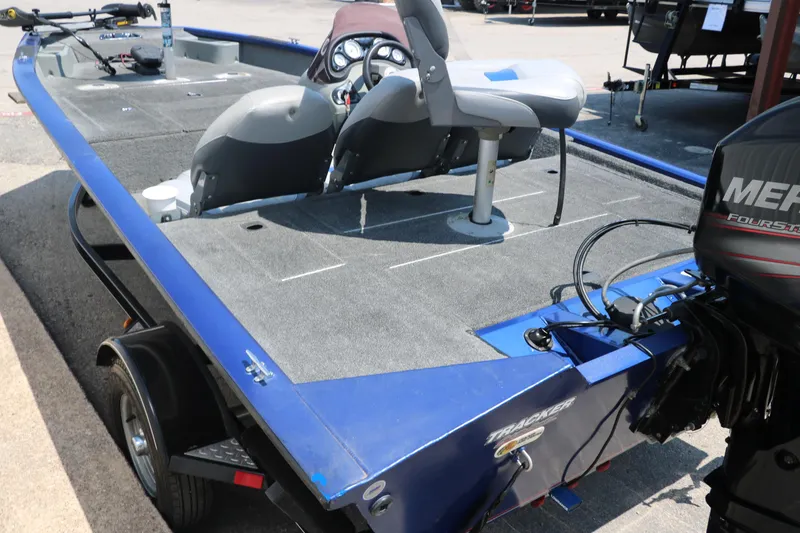 Slide: The Image of 2014 Bass Tracker PT175TF boat with Mercury engine, featuring spacious deck and seating. - 6