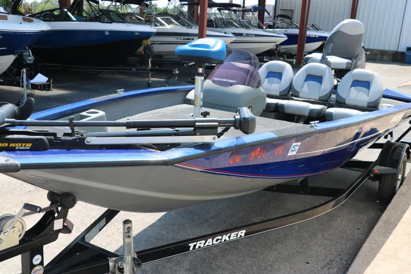 Slide: The Image of 2014 Bass Tracker PT175TF boat on trailer, blue and gray, parked outdoors. - 7