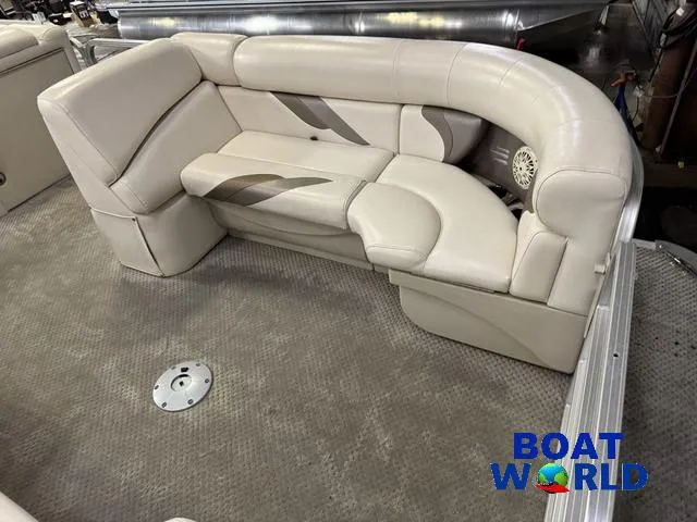 Slide: The Image of 2008 SunChaser 8522 boat interior with beige seating and carpeted floor. - 10