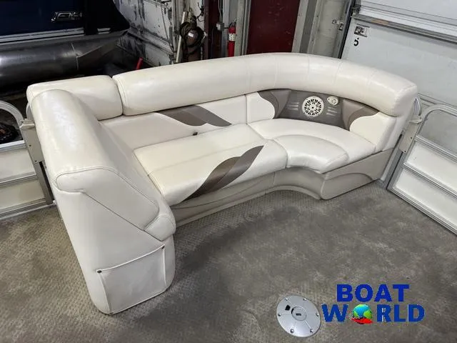 Slide: The Image of White SunChaser 8522 boat seating, 2008 model, in a showroom with "Boat World" logo. - 12