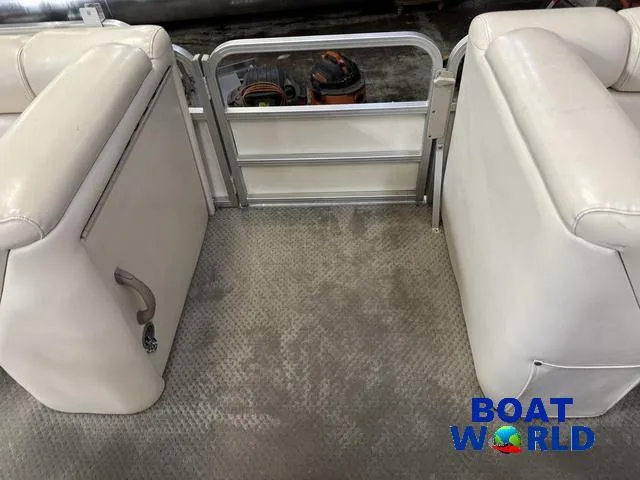 Slide: The Image of Interior of 2008 SunChaser 8522 boat with white seating and metal gate. - 13