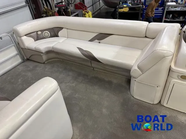 Slide: The Image of 2008 SunChaser 8522 boat interior with beige seating in a workshop setting. - 14