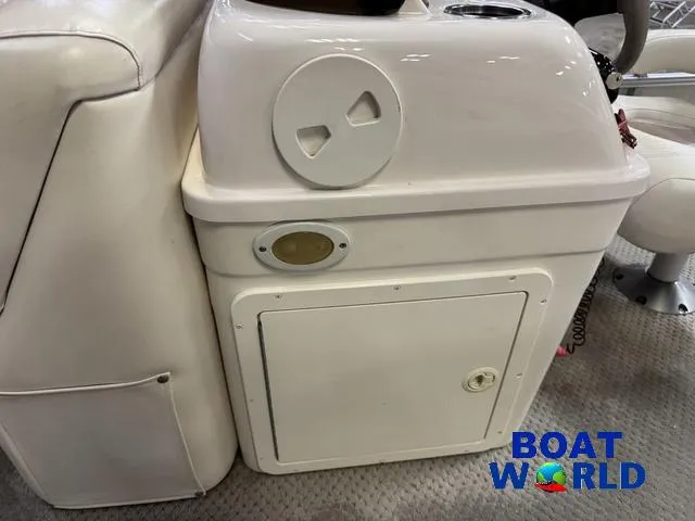 Slide: The Image of 2008 SunChaser 8522 boat interior console with storage compartment, featuring Boat World logo. - 17