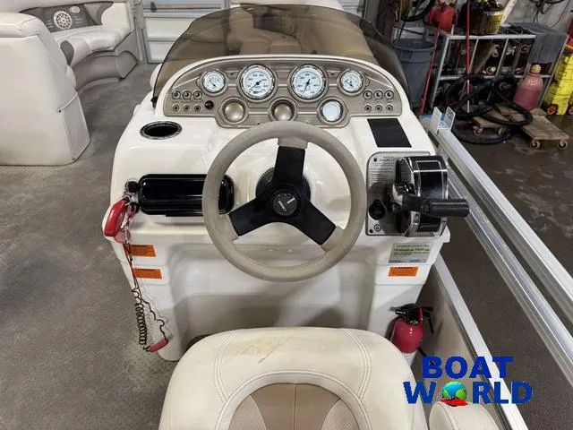 Slide: The Image of 2008 SunChaser 8522 boat dashboard with steering wheel and gauges in a showroom. - 20