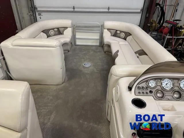 Slide: The Image of 2008 SunChaser 8522 pontoon boat interior with beige seating and control panel. - 3