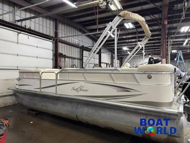 Slide: The Image of 2008 SunChaser 8522 pontoon boat in a warehouse, featuring a beige and white design. - 34