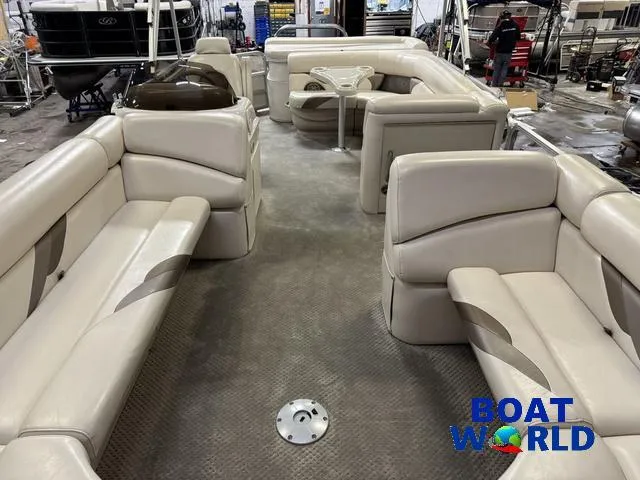Slide: The Image of 2008 SunChaser 8522 pontoon boat interior with beige seating, displayed at Boat World showroom. - 37