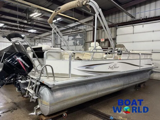 Slide: The Image of 2008 SunChaser 8522 pontoon boat in a garage, featuring a Mercury outboard motor. - 38