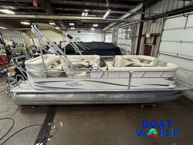 Slide: The Image of 2008 SunChaser 8522 pontoon boat in a garage, featuring beige seating and metal railings. - 4