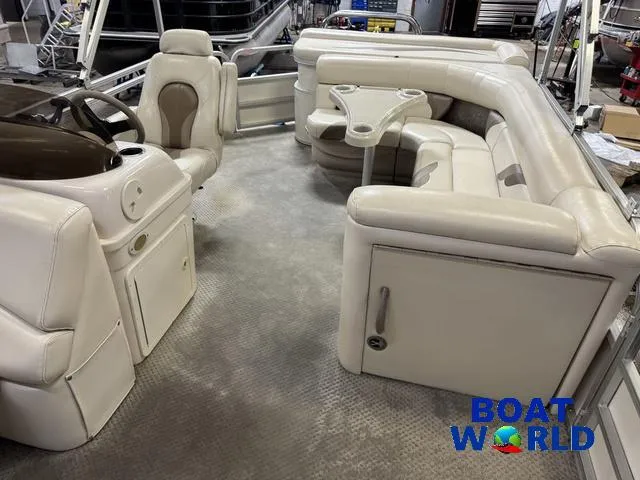 Slide: The Image of Interior of a 2008 SunChaser 8522 pontoon boat with beige seating and steering console. - 5