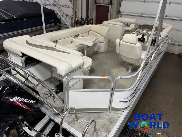 Slide: The Image of 2008 SunChaser 8522 pontoon boat with white seating and Mercury engine in a garage. - 7