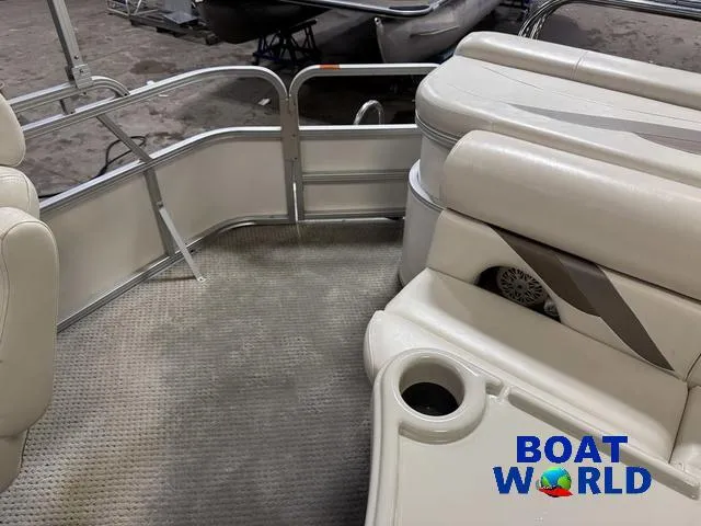 Slide: The Image of Interior of a 2008 SunChaser 8522 pontoon boat with beige seating and carpet. - 8