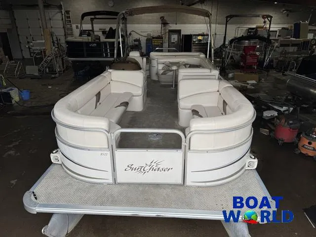 Slide: The Image of 2008 SunChaser 8522 pontoon boat in a workshop setting, featuring spacious seating. - 9